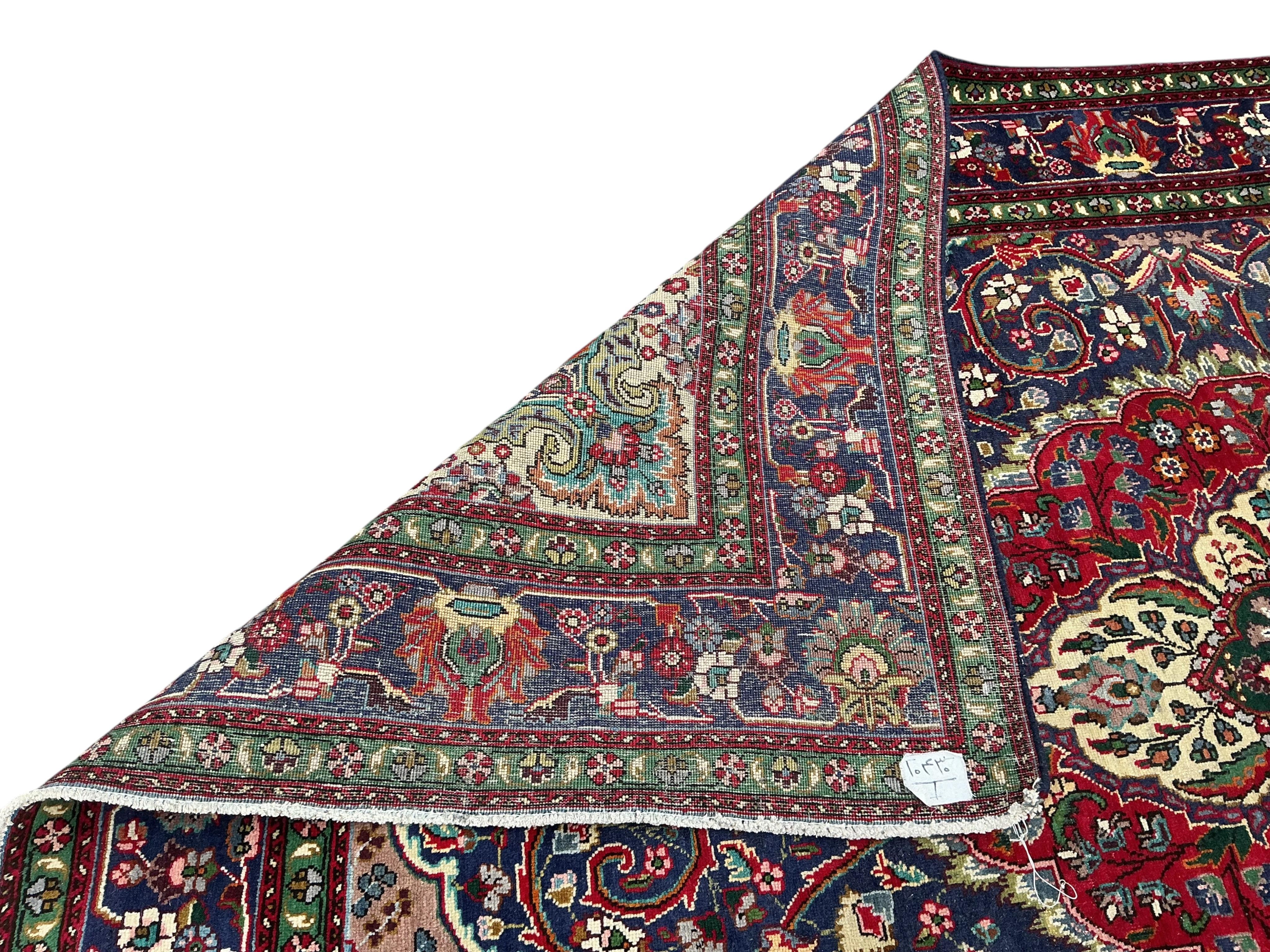 A Tabriz blue ground carpet, 292 x 205cm